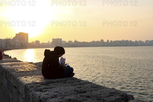 Alexandria, Egypt. December 1st 2022 A Muslim Egyptian female student studying on the corniche