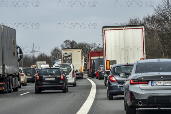 Driving on the A57 motorway, at the Kamp-Lintfort interchange, 3 lanes, traffic jam due to