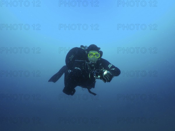 A diver in full gear floats in deep blue water. Giuseppe Dezza wreck dive site, Pula, Croatia,