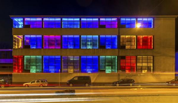 Colourfully illuminated window front in a Frankfurter Mainova AG building, city center, Frankfurt