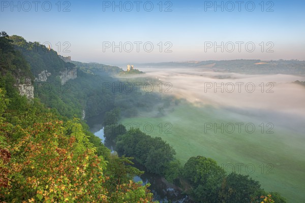 View of the ruins of Saaleck and Rudelsburg castles and the river Saale in autumn morning fog in