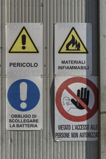 Warning signs on a factory gate, Veneto, Italy