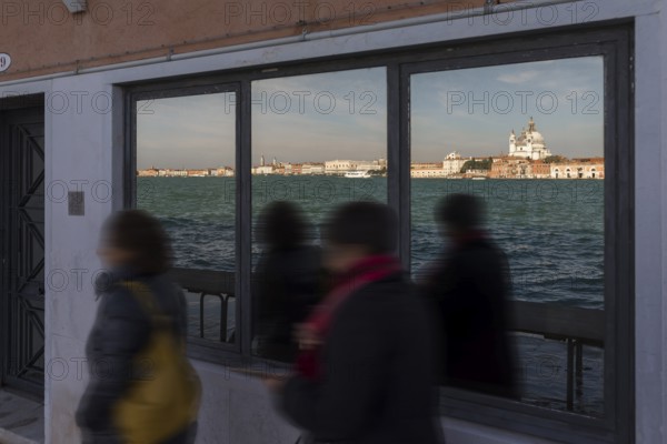 Santa Maria della Salute is reflected in a shop window on the island of Giudecca, Venice, Veneto,