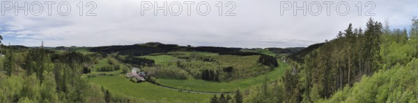 Panorama, far-reaching view over green meadows, fields and wooded hills, hiking on the Rennsteig,