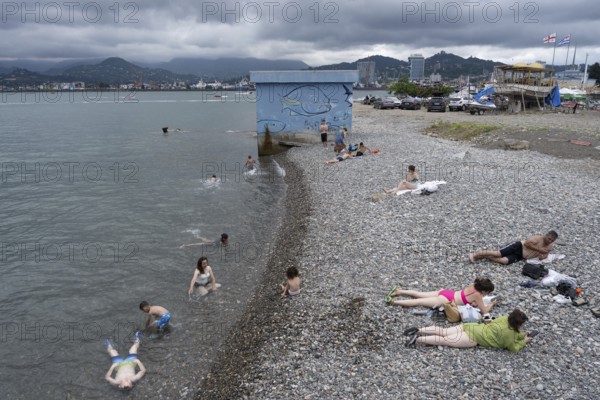 Batumi, Georgia. July 21st 2025. Georgian locals relax on the beach near Batumi Port on the Black