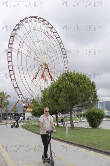 Batumi, Georgia. July 21st 2025. Visitors and tourists ride electric scooters along a dedicated