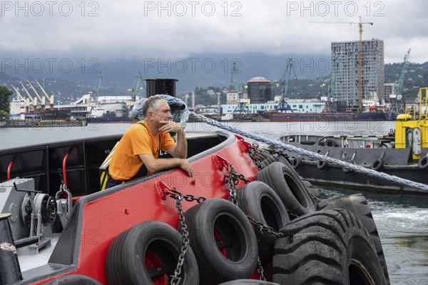 Batumi, Georgia. July 21st 2025. A local worker at Batumi Port, largest container, ferry, general