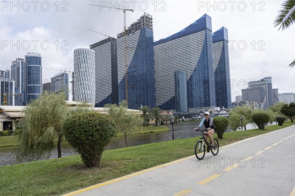 Batumi, Georgia. July 21st 2025. A woman cycles along a dedicated cycle path beside the Georgian