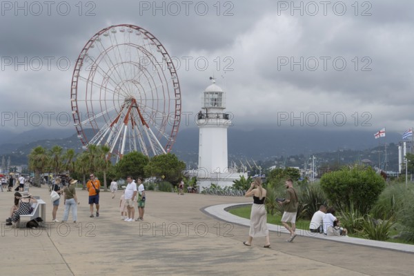 Batumi, Georgia. July 21st 2025. A light house and Ferris wheel near Batumi Port, a popular