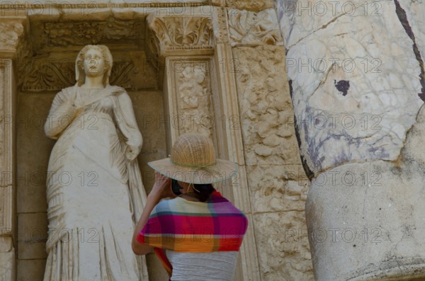 Ephesus, Turkey. July 2nd 2015 A foreign tourist takes a photogaph of a Greek statue at Ephesus,