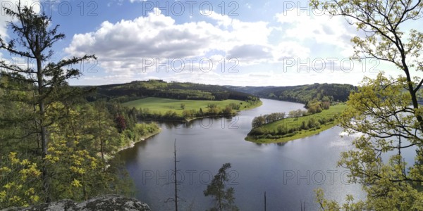 An impressive view of the meandering Saale between green hills and forests, hiking in the