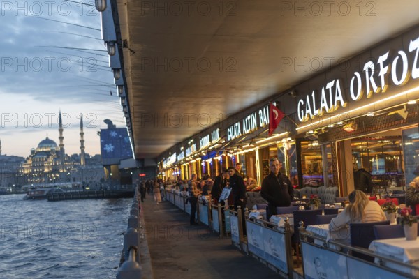 Istanbul, Turkey. January 3rd 2025 Fish restaurants at night on the the iconic Galata Bridge at the