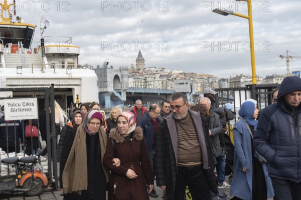 Istanbul, Turkey. January 3rd 2025 A crowd of passengers disembark the ferry from the Asian side of