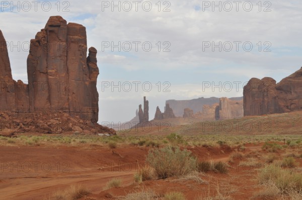 Wide, dry landscape with distinctive rocks and red sand, Monument Valley, Navajo Tribal Park,