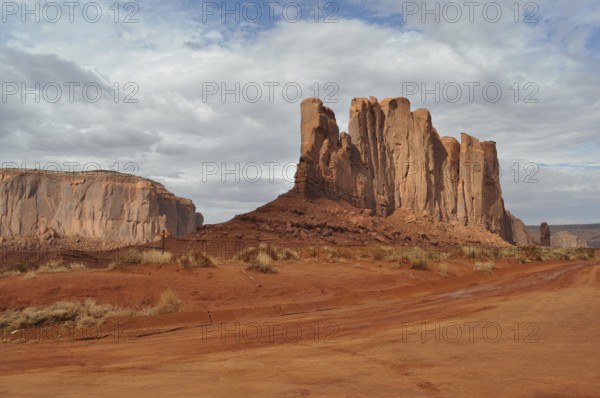 Impressive rock formations stand in a vast red desert landscape, Monument Valley, Navajo Tribal