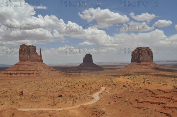 Three distinctive rocks in Monument Valley against a dramatic cloudy sky, Monument Valley, Navajo