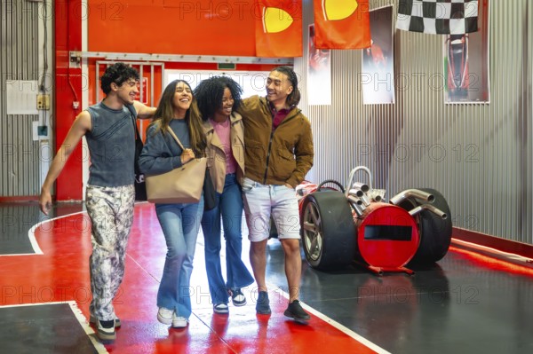 Group of four diverse young adult friends walking together and laughing, finding happiness and