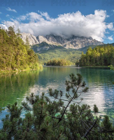 View over Lake Eibsee lake, the Wetterstein Mountains with the Zugspitze in the background, clouds