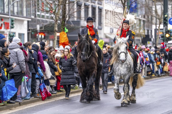 Rose Monday procession in Düsseldorf, group of horses at the street carnival, sometimes heavy rain,