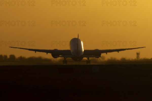 Boeing 777 A7-BFL commercial jet aircraft of Qatar cargo taking off in flight silhouette at sunset
