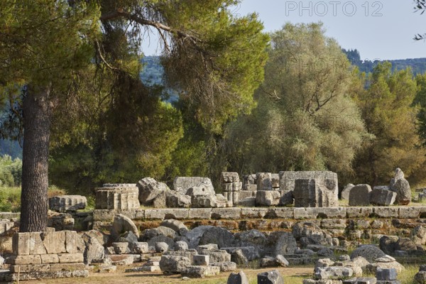 Hera Temple, Heraion, Ancient stone structures surrounded by trees in an idyllic landscape,