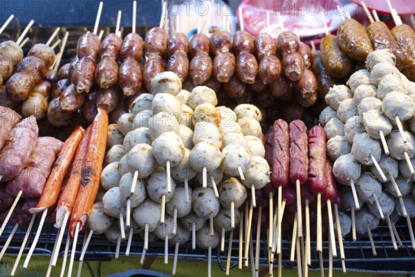 A selection of grilled pork meat sausages including Sai Krok Isan and Moo Ping, satay style meat on