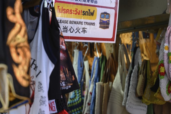 Mae Klong, Thailand. March 15th 2025. A sign warning tourists to beware of the train at the Mae