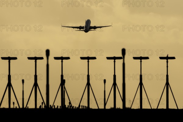 Commercial passenger airliner jet aircraft taking off in flight at sunset at London Stansted