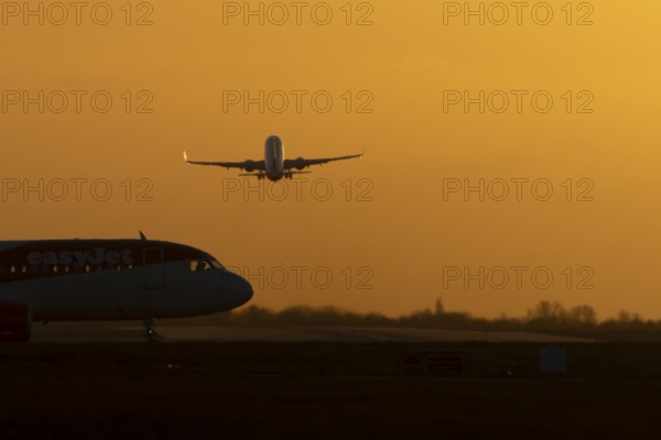 Airbus commercial passenger airliner jet aircraft taking off in flight with another plane on the
