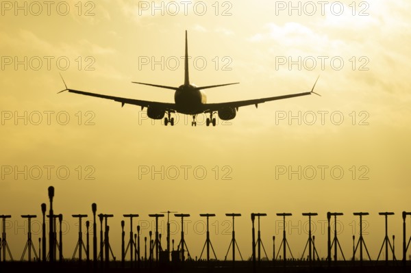 Boeing 737 commercial passenger airliner jet aircraft in flight on approach to land over runway