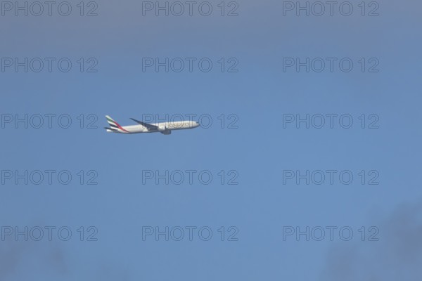 Boeing 777 commercial passenger airliner jet aircraft of Emirates airways in flight at London