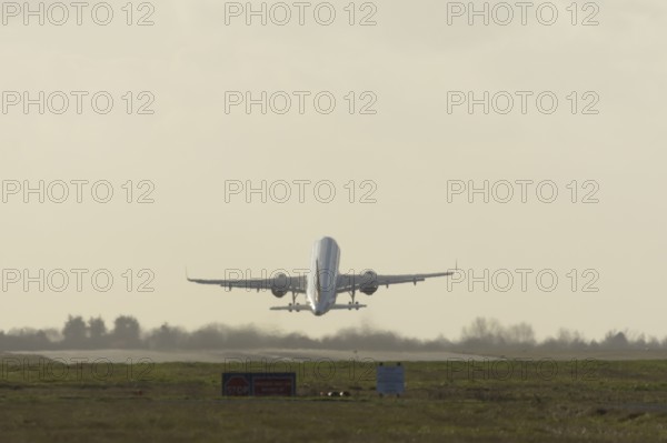 Airbus commercial passenger airliner jet aircraft taking off in flight at London Stansted airport,