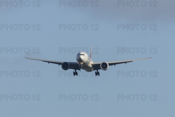 Boeing 777 commercial passenger airliner jet aircraft of Emirates airways in flight on approach to