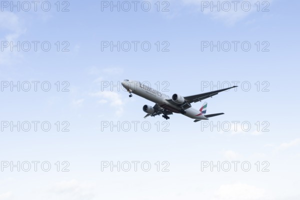 Boeing 777 commercial passenger airliner jet aircraft of Emirates airways in flight on approach to