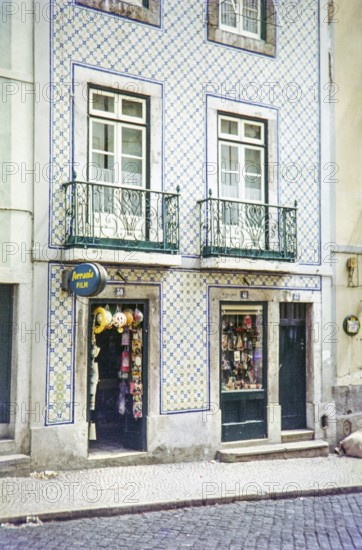 Typical Portuguese building facade with blue and white azulejo tiles shop selling film and