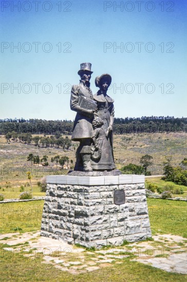 Bronze statue of a Victorian-era settler family (a man, woman, and child) at the 1820 Settlers