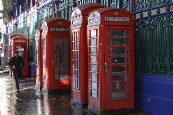 London, UK. January 30th 2025. A man walks past a row of old fashioned telephone boxes in