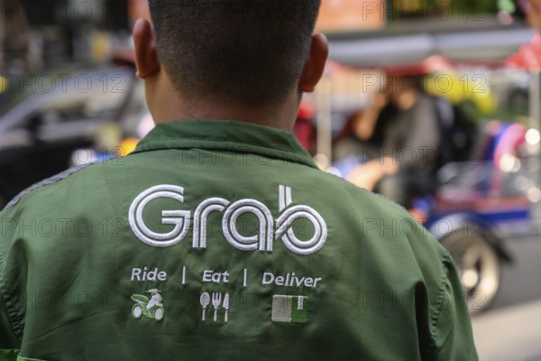 Bangkok, Thailand. March 25th 2025. A Grab food delivery service logo displayed on the shirt of a