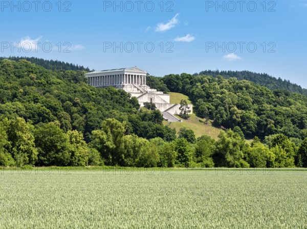 View across a green cornfield to the Walhalla Memorial on the Bräuberg, Donaustauf, Upper