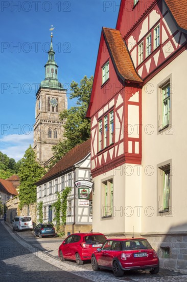 Street with half-timbered houses and cobblestones at the Gothic St. Mary's Church, Königsberg in