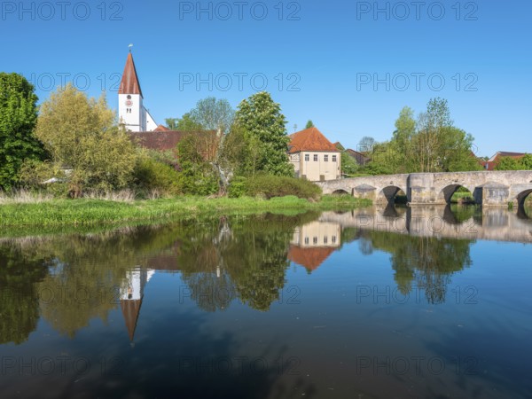 The small village of Ebermergen with church tower and stone bridge, medieval stone bridge over the