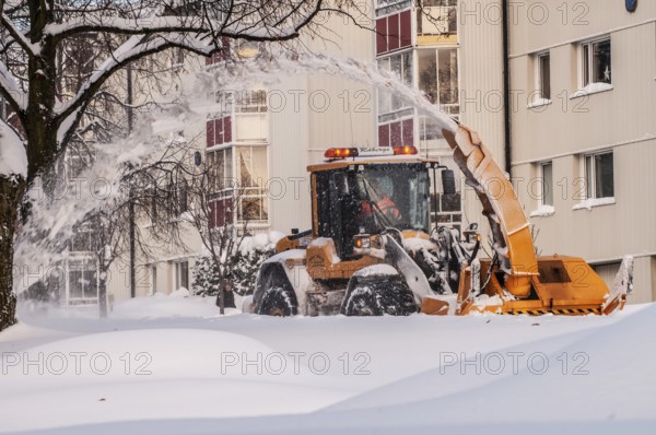 Snow blower clears snow on street in Ystad, Skåne County, Sweden, Scandinavia