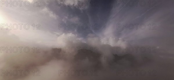 Gentle fog and cloud formations over a mountain landscape at dusk, hiking in the High Tatras