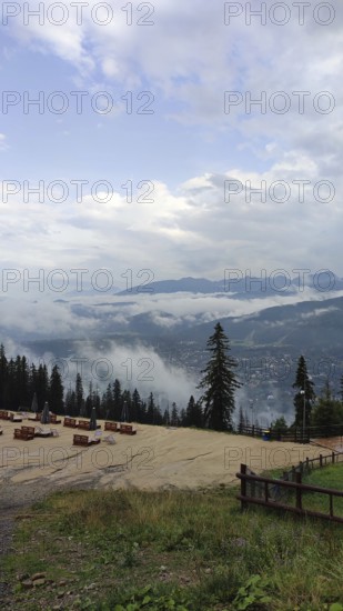 Panoramic view from a viewpoint on Mount Gubalowka with clouds, mountains and a town in the valley,