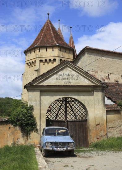 The fortified church of Seica Mica, German Kleinschelken, in front of it a Daccia 1300, a community