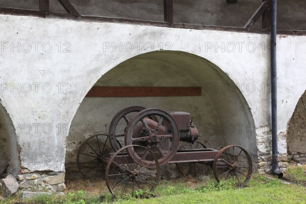 Old agricultural equipment within the defensive wall of the fortified church of Valea Viilo, German