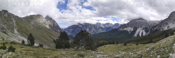 Extensive mountain panorama with forests between rocky peaks and clouds, Peaks of the Balkans,