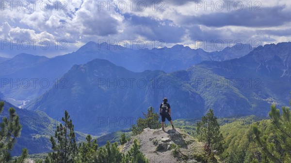 Hikers on peaks with views of mountain scenery and dramatic skies, Peaks of the Balkans, hiking in