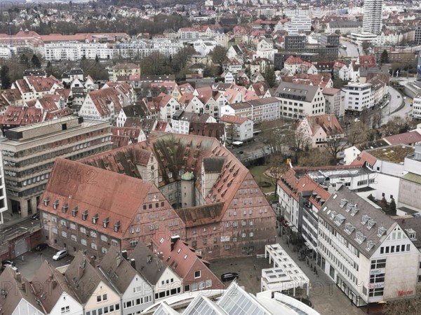 Panoramic view of a city with characteristic red roofs and modern buildings, view from Ulm Minster,