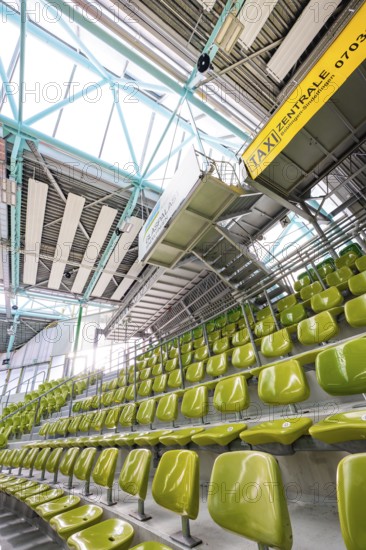 Yellow seats in a stand in a modern sports hall, Glaspalast Sindelfingen, Böblingen district,
